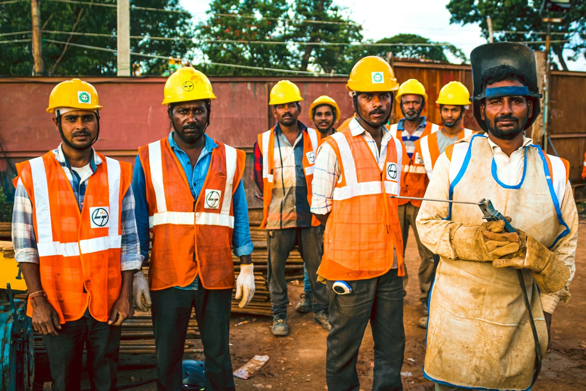 Industrial workers in hard hats and safety vests
